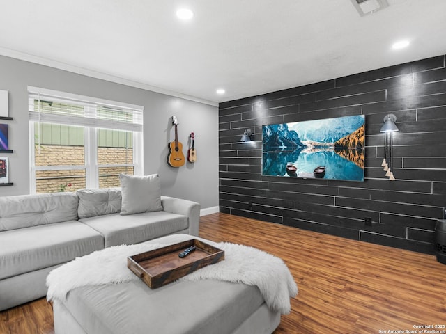 home theater with wood-type flooring and crown molding