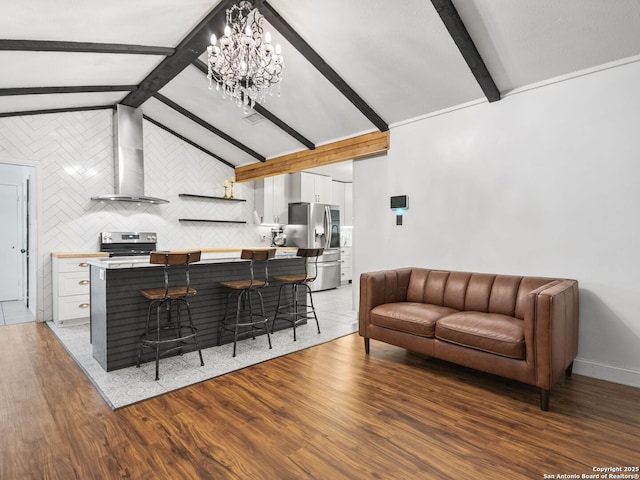 living room featuring a notable chandelier, vaulted ceiling with beams, and dark wood-type flooring