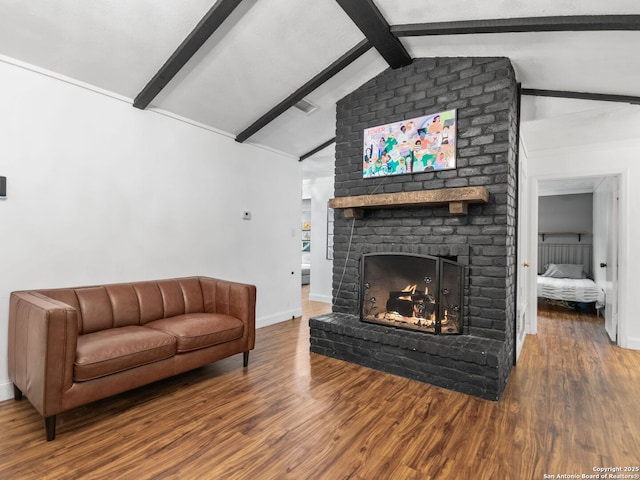 living room featuring a fireplace, wood-type flooring, and lofted ceiling with beams