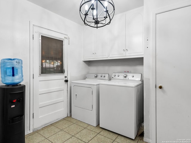 laundry room featuring cabinets, light tile patterned floors, washer and dryer, and an inviting chandelier