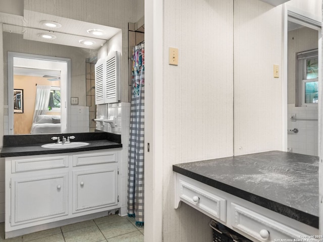 bathroom with vanity, tile patterned floors, tile walls, and ceiling fan