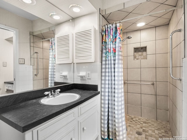 bathroom featuring a shower with curtain, vanity, radiator heating unit, and tasteful backsplash