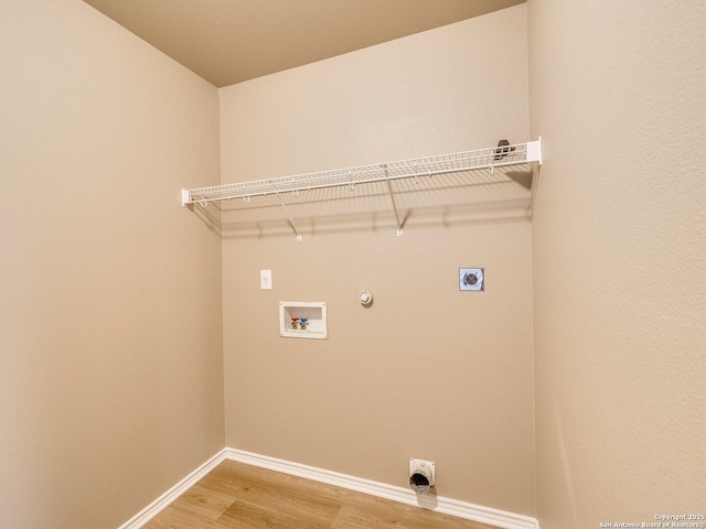 laundry room with hookup for an electric dryer, hookup for a gas dryer, hardwood / wood-style flooring, and washer hookup