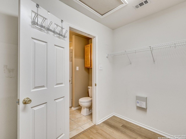 bathroom featuring hardwood / wood-style floors and toilet