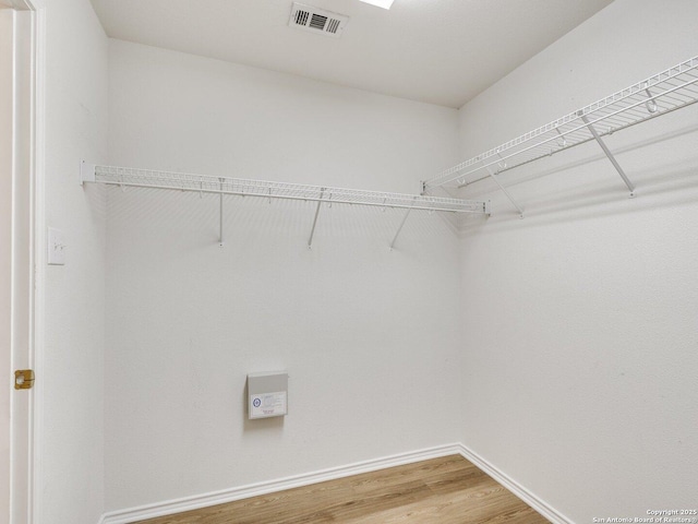 walk in closet with wood-type flooring