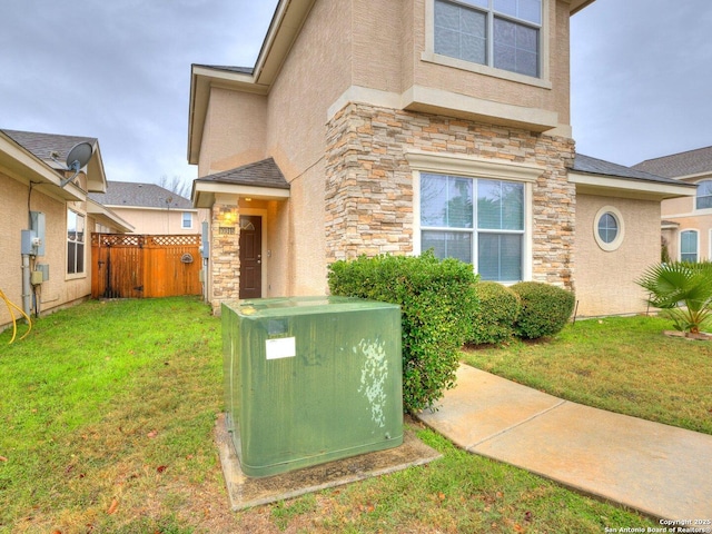 view of exterior entry with a yard