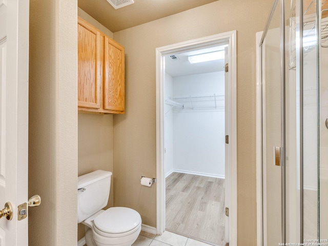 bathroom featuring toilet and wood-type flooring