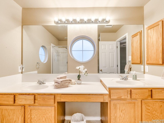 bathroom featuring vanity and an enclosed shower