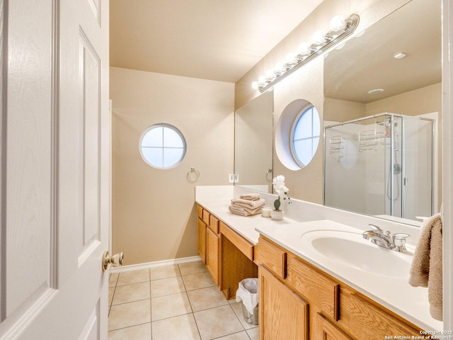 bathroom featuring tile patterned flooring, vanity, and walk in shower