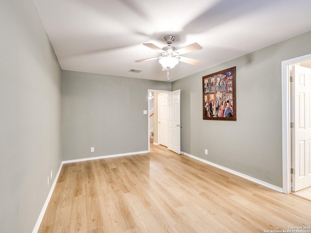 empty room featuring ceiling fan and light wood-type flooring