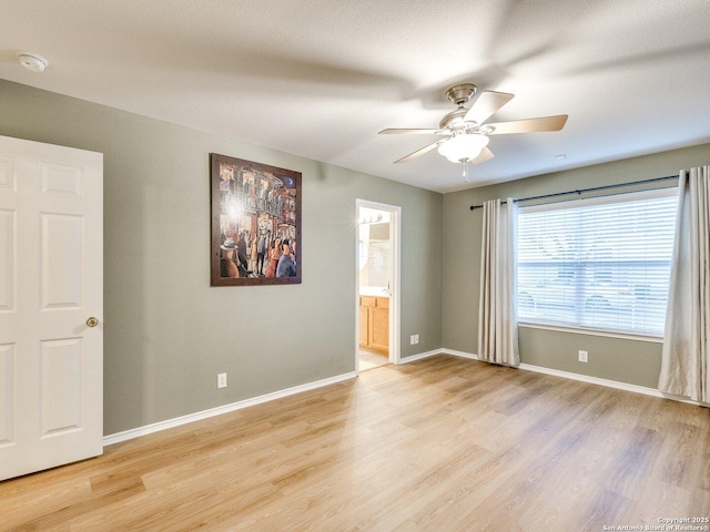 spare room featuring ceiling fan and light hardwood / wood-style floors