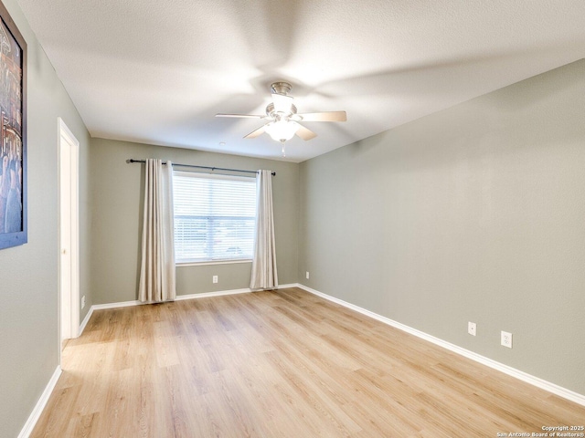 spare room featuring ceiling fan, light hardwood / wood-style floors, and a textured ceiling