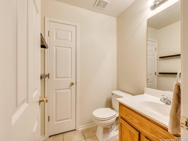 bathroom featuring tile patterned floors, vanity, and toilet