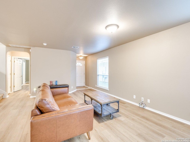 living room featuring light hardwood / wood-style floors and a textured ceiling