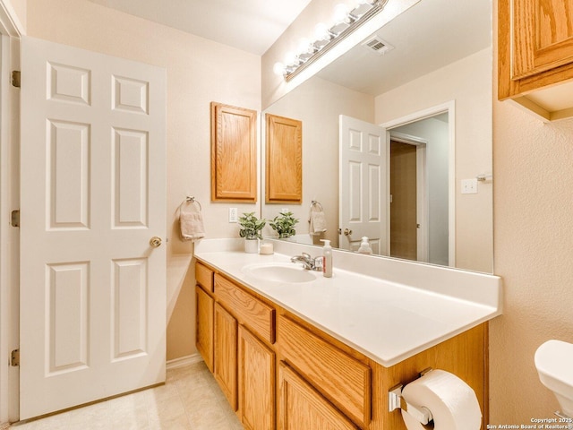 bathroom featuring vanity and toilet