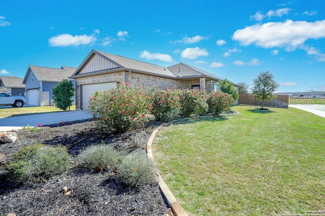 view of front of property with a front yard and a garage