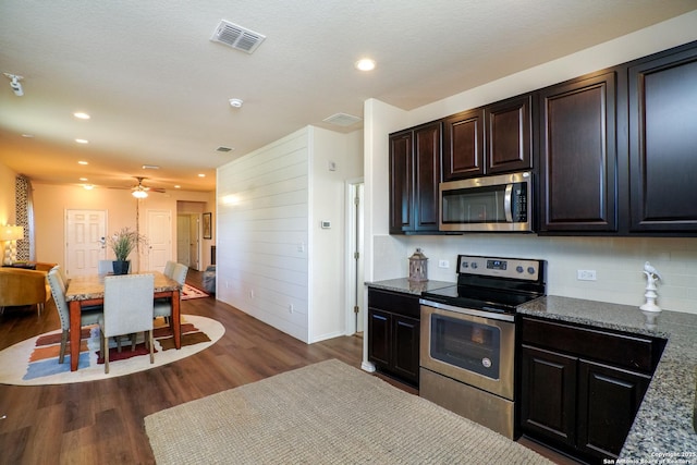 kitchen with ceiling fan, tasteful backsplash, stainless steel appliances, and dark wood-type flooring