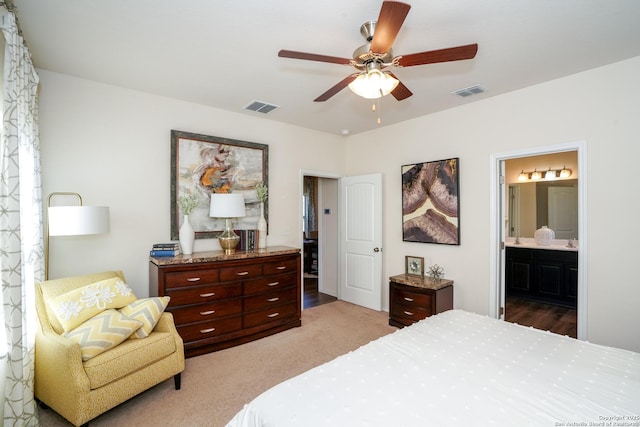 bedroom featuring carpet flooring, ensuite bathroom, and ceiling fan