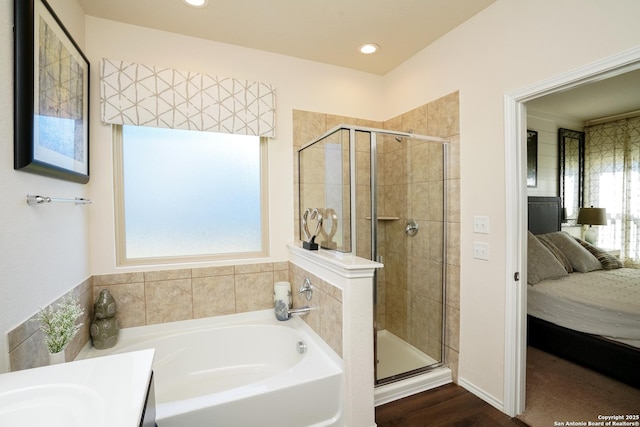 bathroom with separate shower and tub and vanity