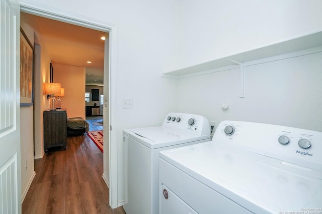 laundry area featuring dark hardwood / wood-style flooring and washer and clothes dryer