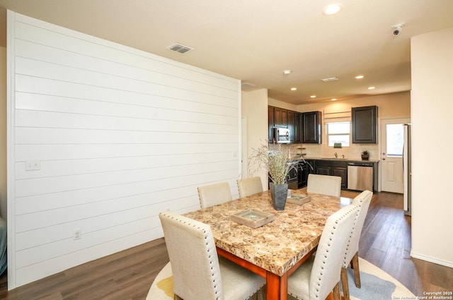 dining room featuring dark hardwood / wood-style floors and sink