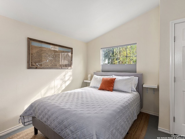 bedroom featuring dark hardwood / wood-style flooring and lofted ceiling