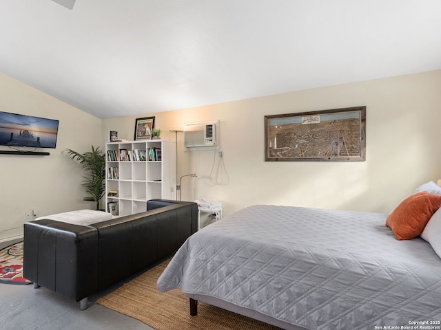 bedroom featuring vaulted ceiling, concrete floors, and a wall mounted AC