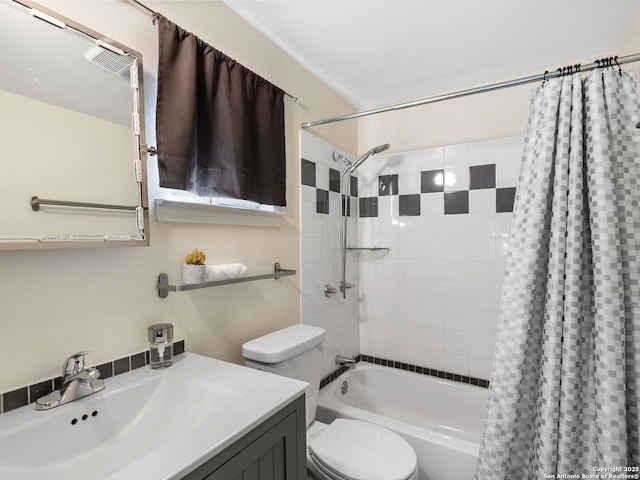 full bathroom featuring vanity, shower / bath combo, and toilet