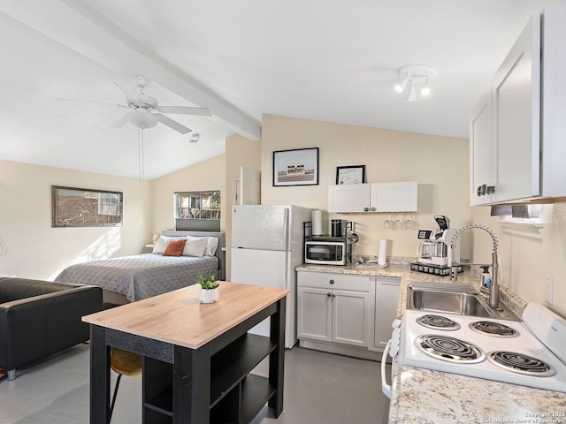 kitchen with white cabinetry, sink, ceiling fan, lofted ceiling with beams, and white appliances