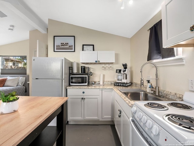 kitchen with white appliances, lofted ceiling with beams, white cabinetry, and sink