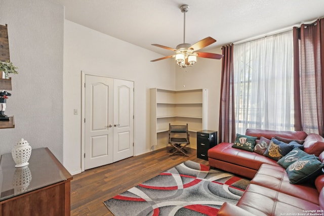 living room featuring lofted ceiling, ceiling fan, and dark hardwood / wood-style floors