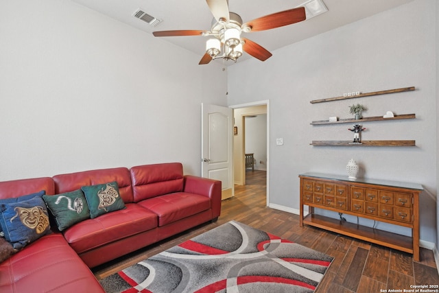 living room featuring dark hardwood / wood-style flooring and ceiling fan