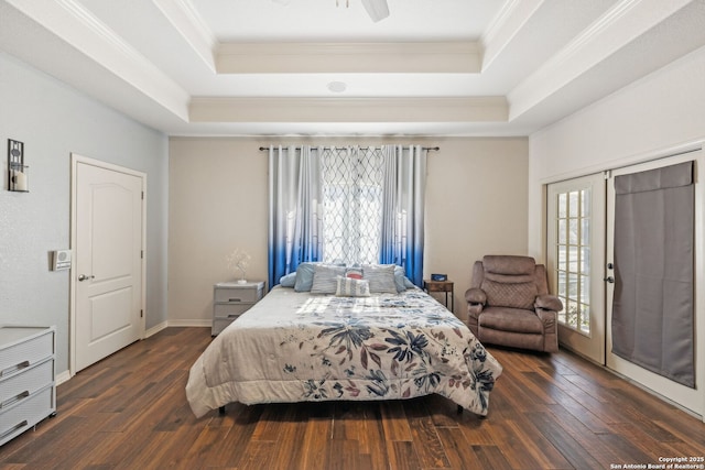 bedroom with a raised ceiling, ceiling fan, french doors, and dark wood-type flooring