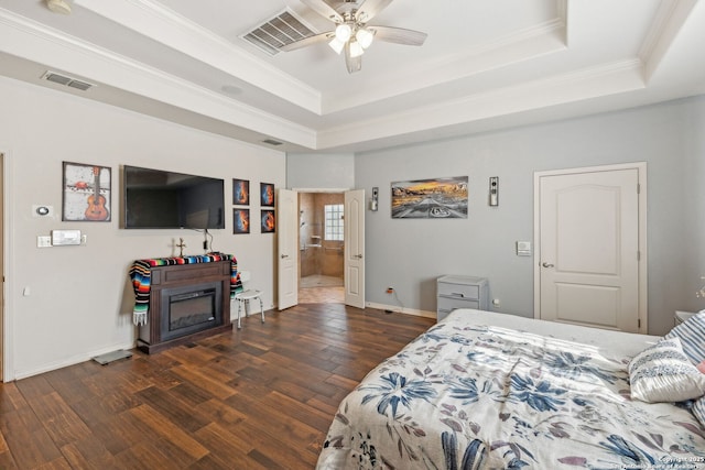 bedroom featuring a raised ceiling, ceiling fan, crown molding, and dark wood-type flooring