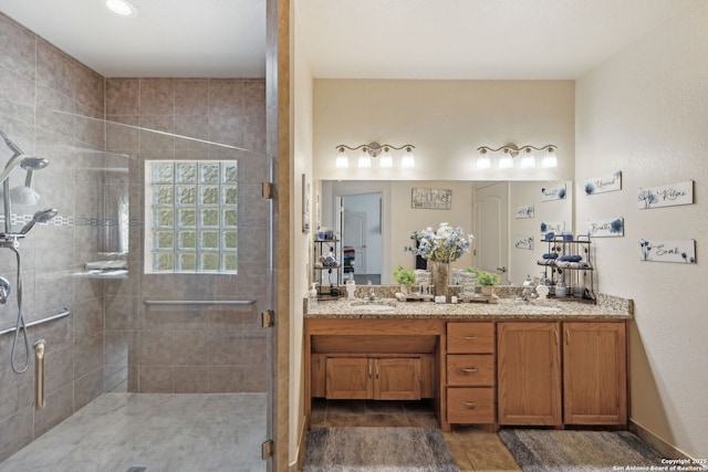 bathroom with tile patterned floors, vanity, and a shower with shower door