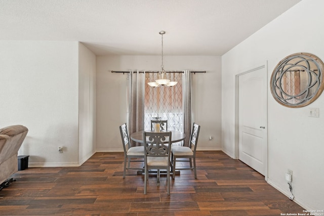 dining room featuring dark hardwood / wood-style floors and a chandelier