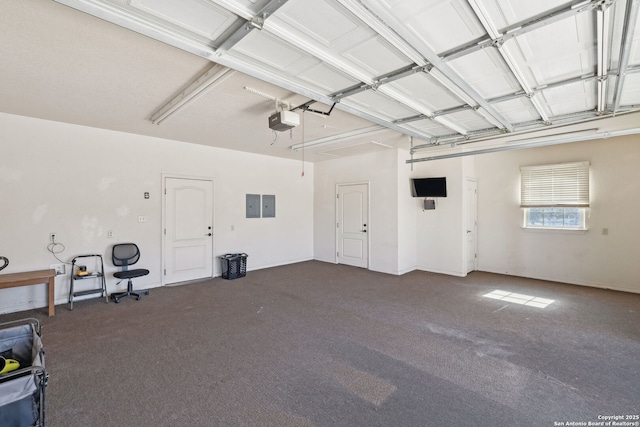 garage featuring electric panel and a garage door opener