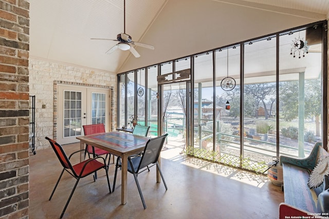 sunroom with ceiling fan, a healthy amount of sunlight, vaulted ceiling, and french doors