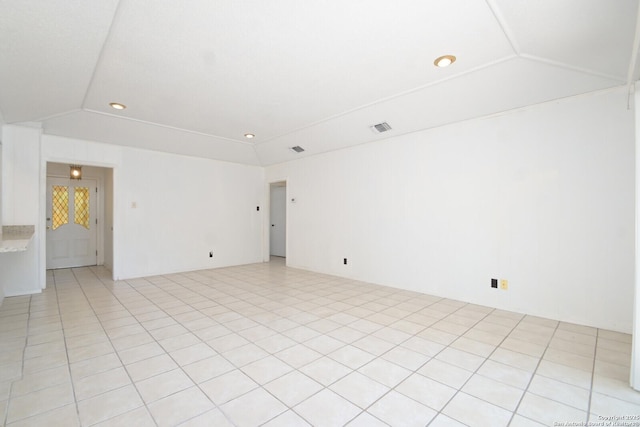 spare room featuring vaulted ceiling