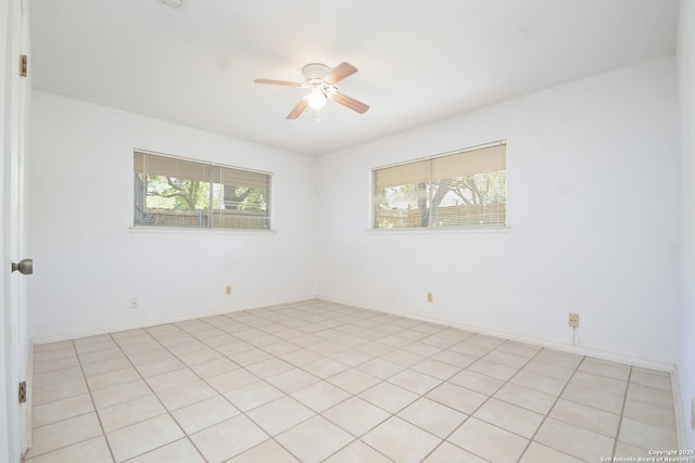 tiled empty room featuring ceiling fan