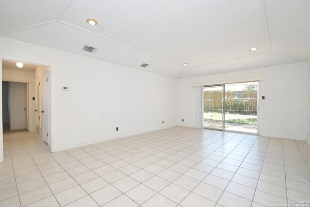 tiled spare room with vaulted ceiling