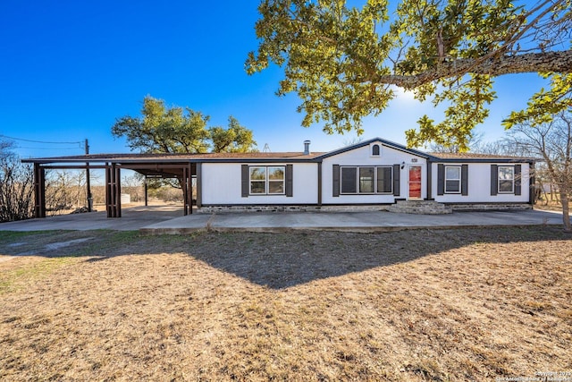 ranch-style home featuring a carport