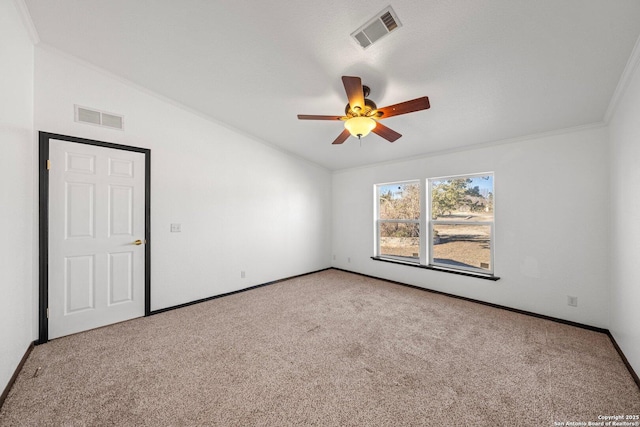 carpeted spare room with ceiling fan and crown molding