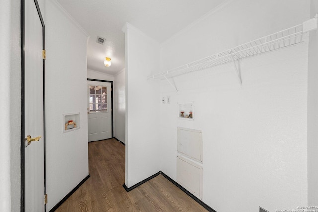 laundry area featuring ornamental molding, washer hookup, and wood-type flooring