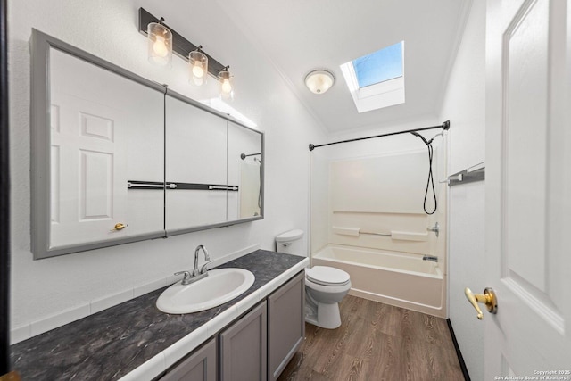 full bathroom featuring shower / bathing tub combination, toilet, hardwood / wood-style flooring, vanity, and ornamental molding