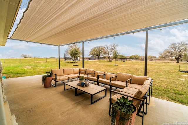 view of patio with outdoor lounge area and a rural view