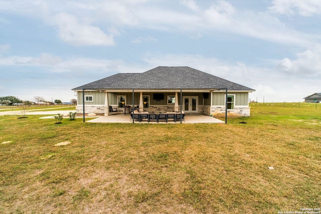 rear view of house featuring a lawn, a patio area, french doors, and an outdoor hangout area