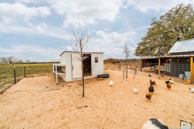 view of outdoor structure with a rural view