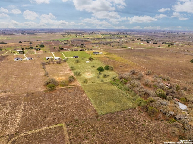 birds eye view of property with a rural view