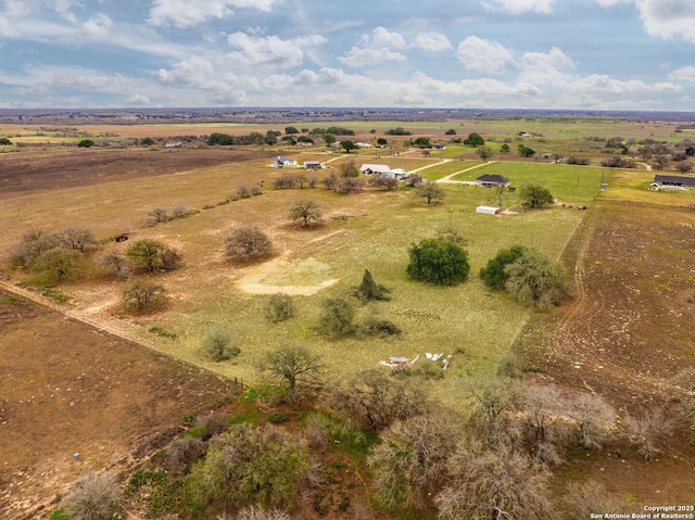 birds eye view of property with a rural view